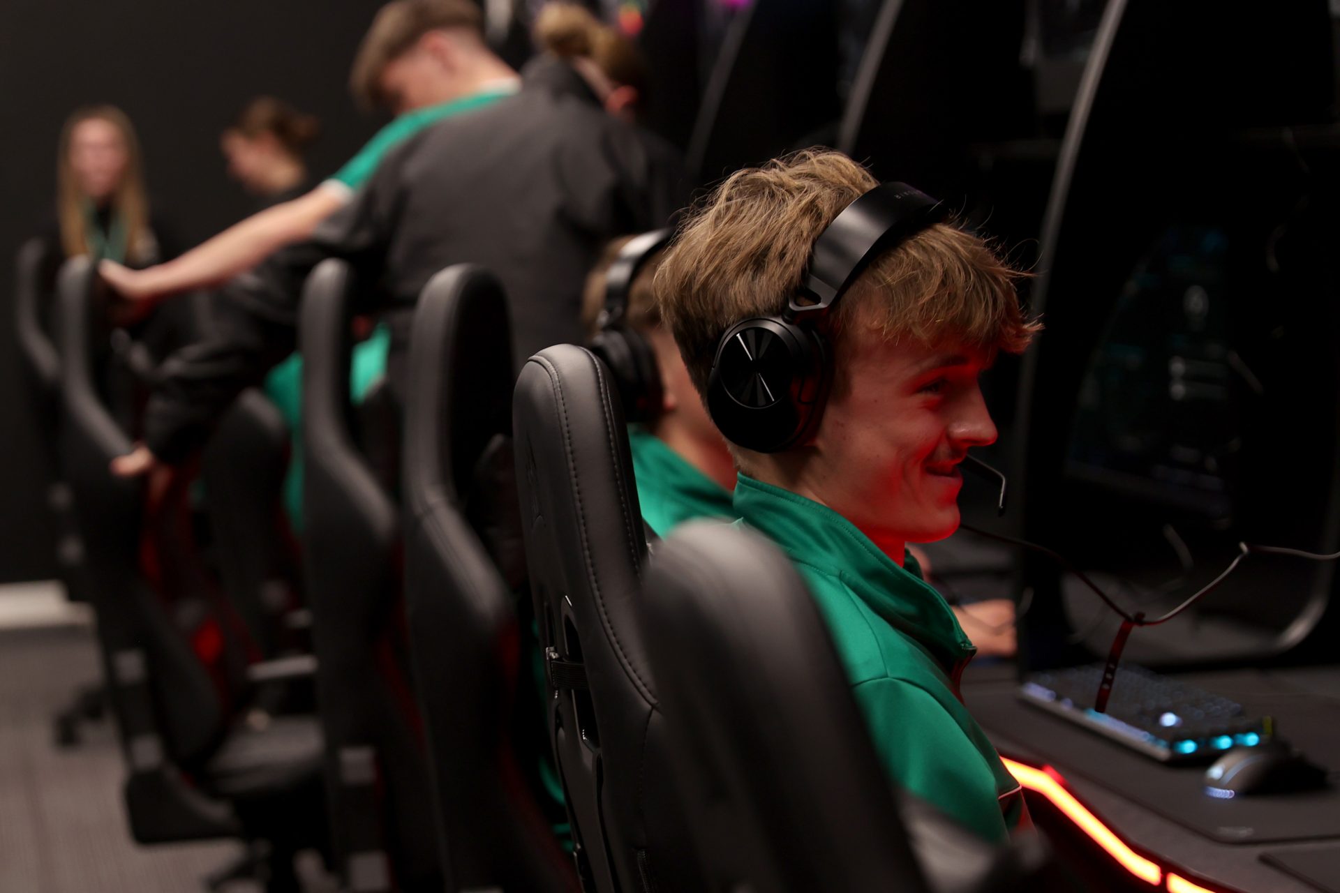 young esports player wearing headset during competitive gaming session