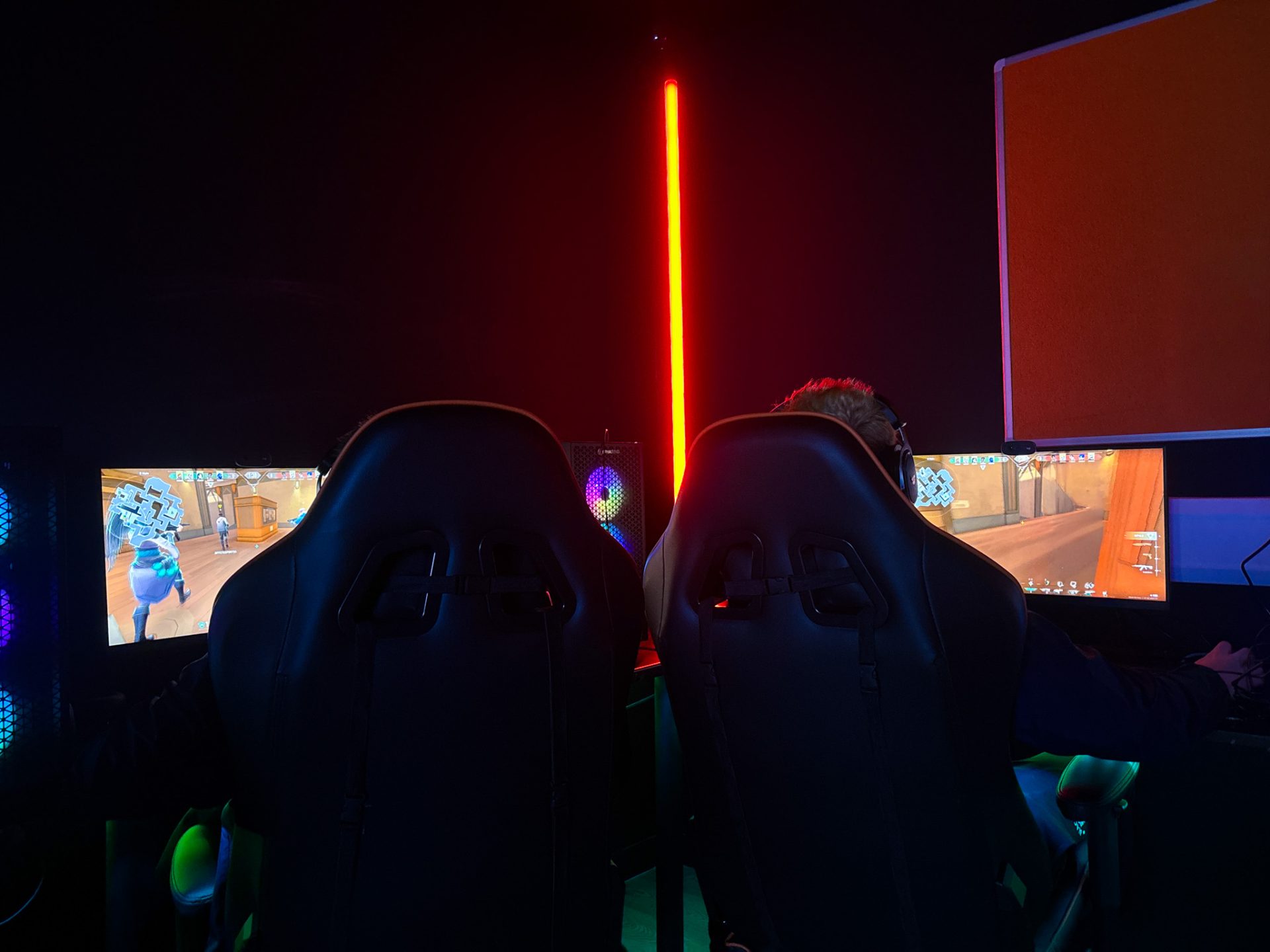 esports gaming setup with dual chairs and monitors in a competitive arena environment